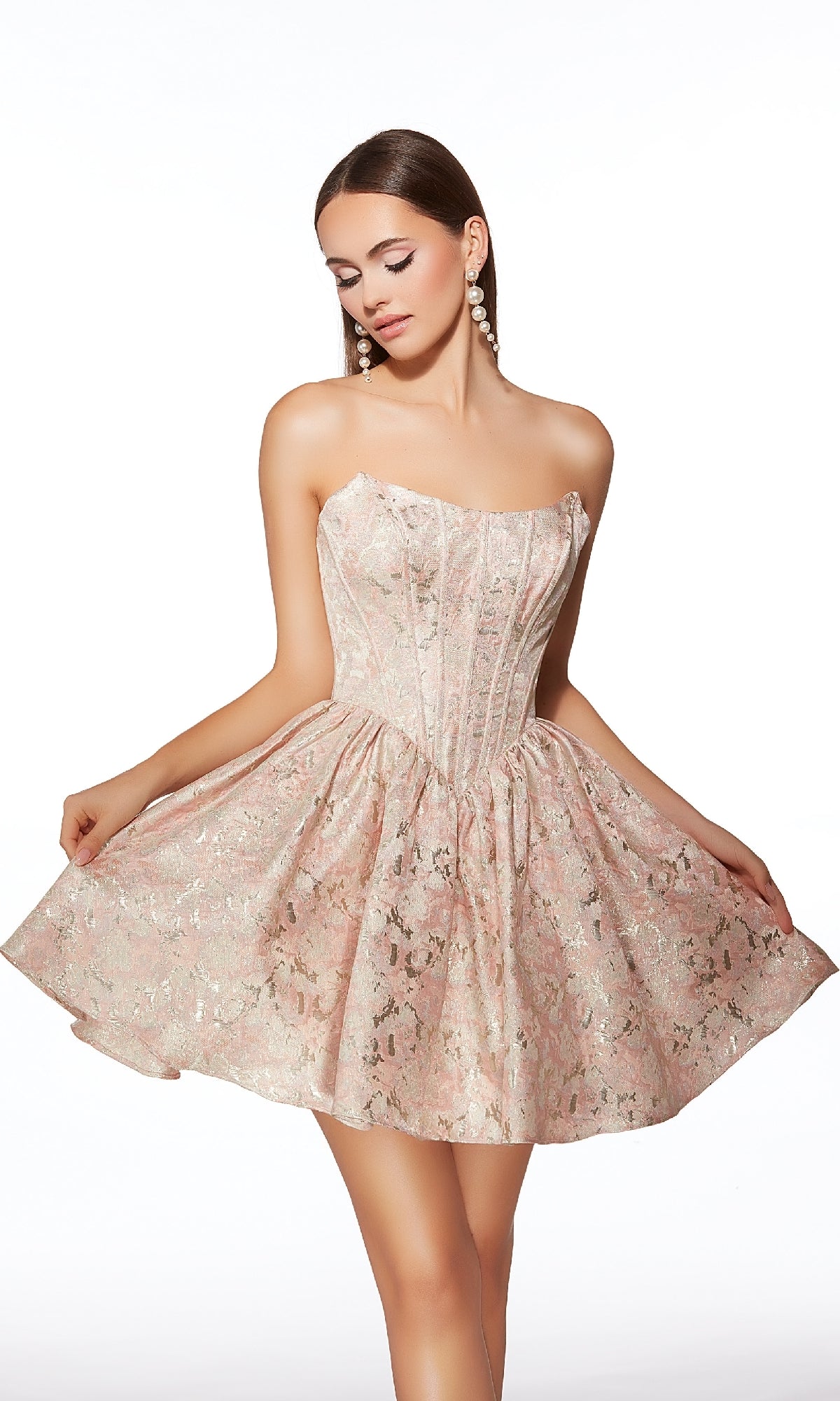A woman models the Short Homecoming Dress: Alyce 30007, a strapless pale pink brocade dress with a floral pattern, corset bodice, and flared fit-and-flare skirt, posed against a white background.